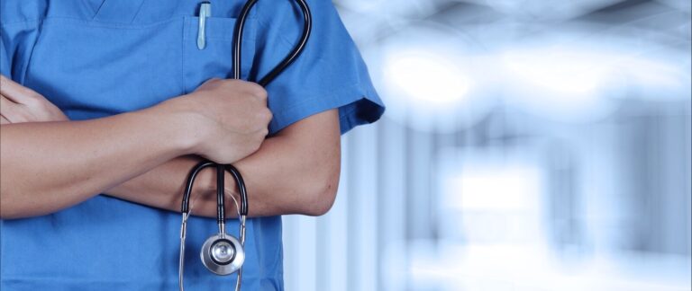 a person in scrubs with a stethoscope on their arm